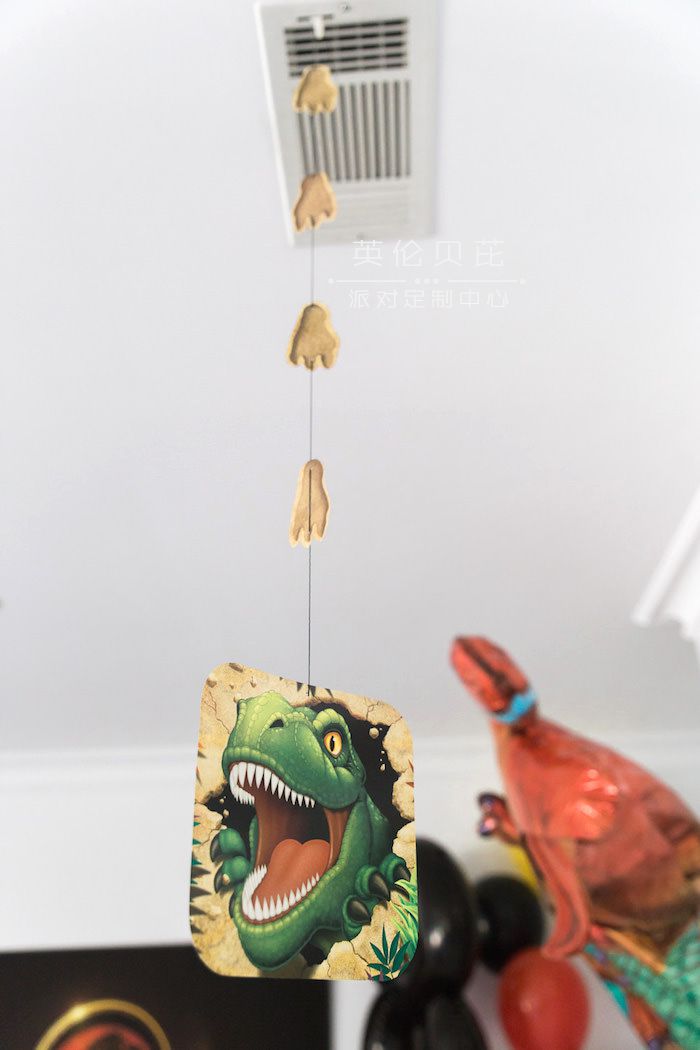 Hanging T-Rex Decoration from a Jurassic Park Dinosaur Birthday Party via Kara